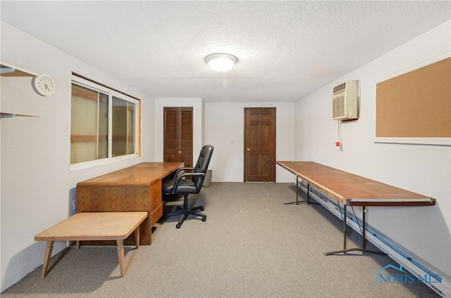 carpeted office space featuring an AC wall unit and a textured ceiling