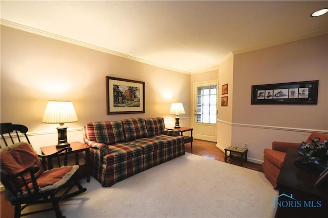 living room with hardwood / wood-style flooring and crown molding