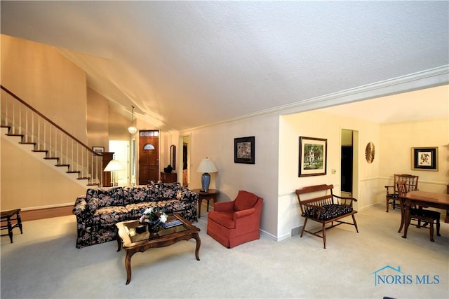 living room with light colored carpet, vaulted ceiling, and ornamental molding