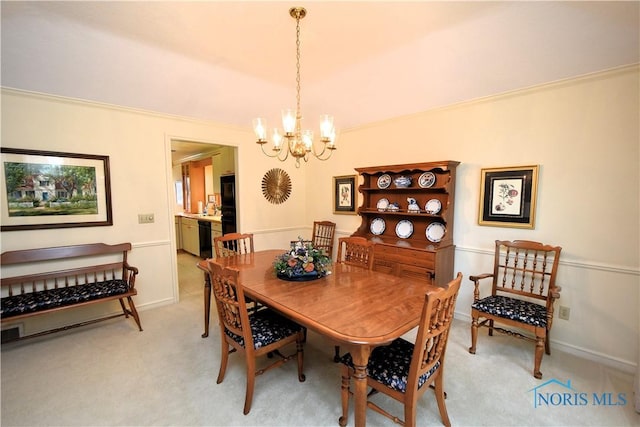 dining space with light carpet, a chandelier, and ornamental molding