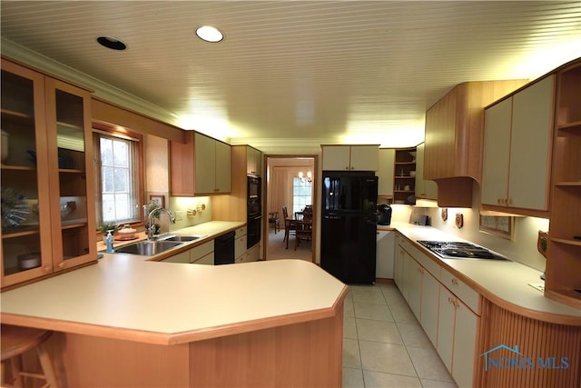 kitchen featuring sink, kitchen peninsula, light tile patterned floors, black appliances, and ornamental molding