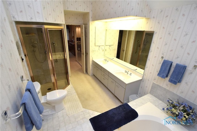 bathroom featuring toilet, a shower with door, vanity, and tile patterned flooring