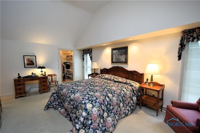 bedroom with a spacious closet, light carpet, high vaulted ceiling, and a closet