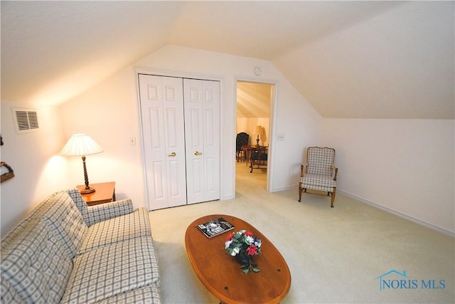 sitting room featuring carpet flooring and lofted ceiling