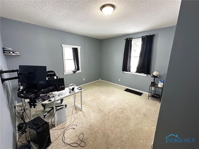 carpeted home office with a textured ceiling