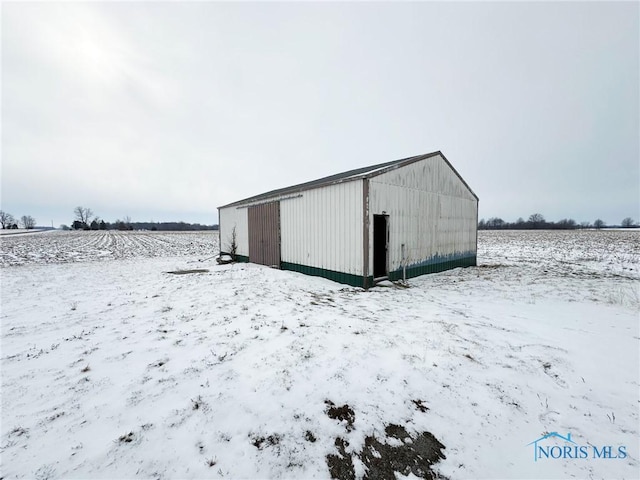 snow covered structure with a rural view