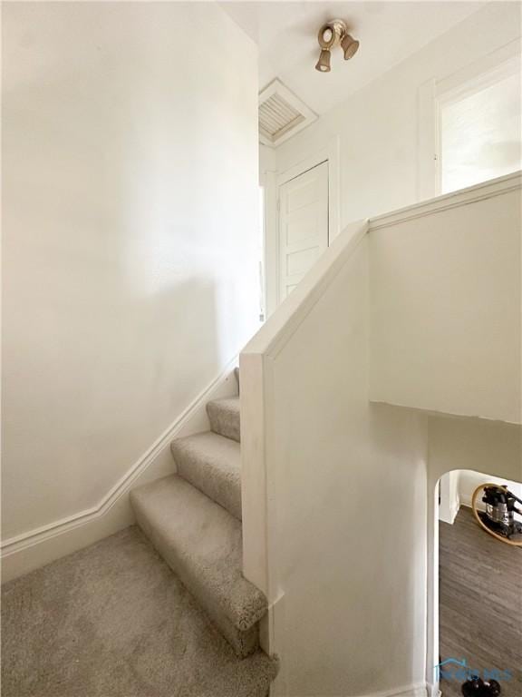 stairway featuring baseboards