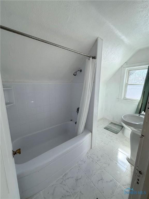 bathroom with shower / tub combo, lofted ceiling, toilet, marble finish floor, and a textured ceiling