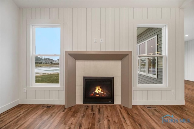 interior details with a fireplace and hardwood / wood-style flooring