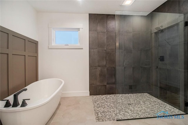 bathroom with plus walk in shower and tile patterned flooring