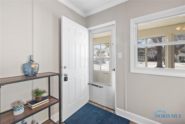 entryway featuring crown molding