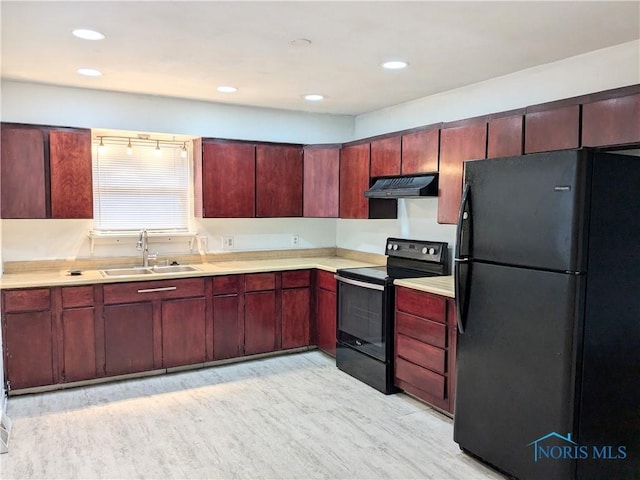 kitchen featuring light wood-type flooring, sink, and black appliances