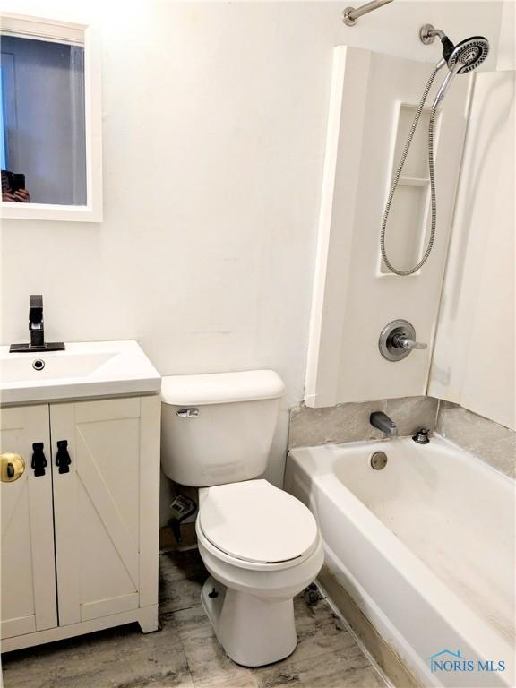 full bathroom with vanity, shower / bathtub combination, toilet, and wood-type flooring