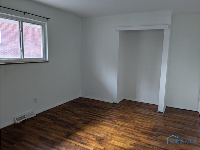 empty room featuring dark hardwood / wood-style floors