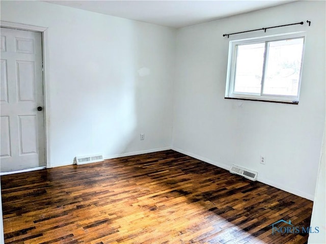 spare room with dark hardwood / wood-style floors