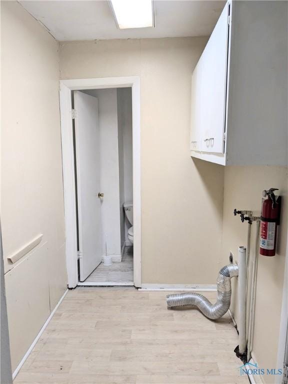 washroom featuring cabinets and light wood-type flooring