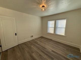 empty room with dark hardwood / wood-style floors