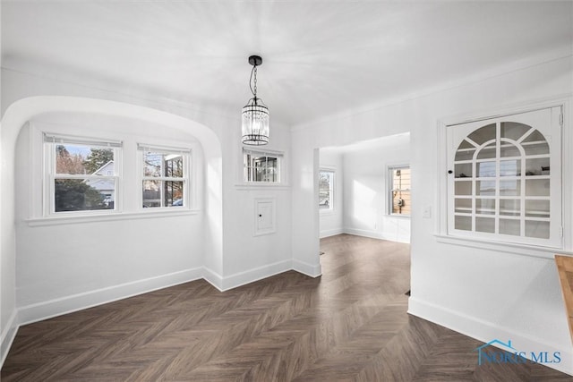 interior space featuring dark parquet floors and a chandelier