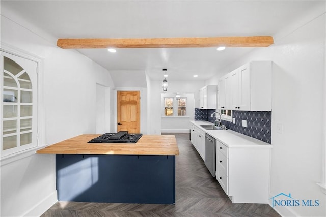 kitchen featuring dark parquet floors, sink, white cabinets, wooden counters, and beam ceiling