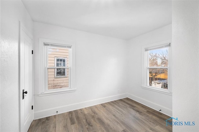 spare room featuring hardwood / wood-style flooring