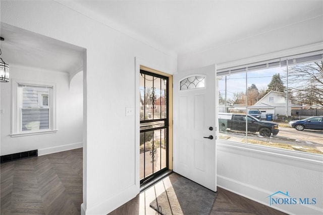 foyer entrance featuring dark parquet floors