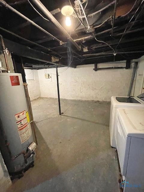 basement featuring washing machine and dryer and gas water heater