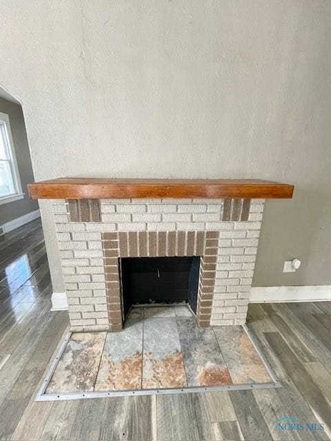 room details with hardwood / wood-style floors and a brick fireplace