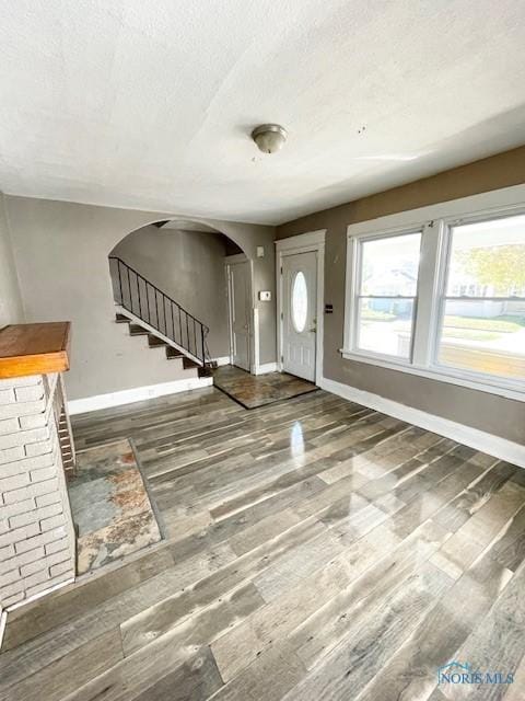 foyer with a textured ceiling and dark wood-type flooring