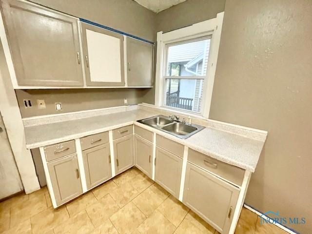 kitchen with white cabinetry and sink