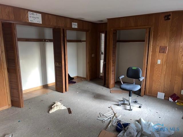 unfurnished bedroom with multiple closets