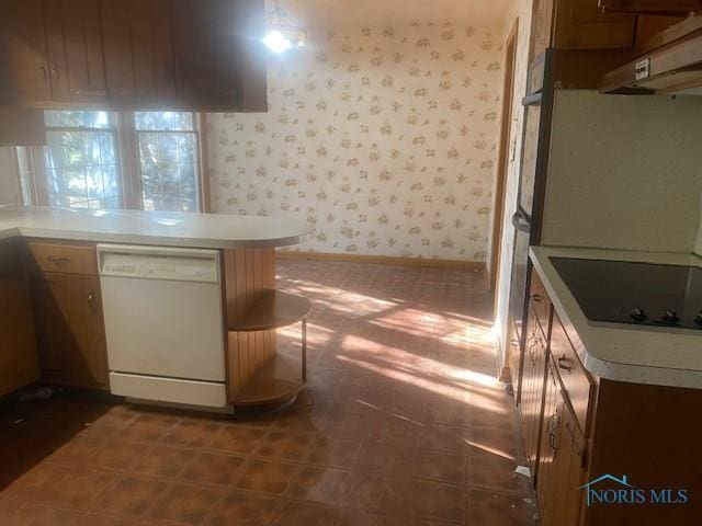 kitchen featuring white dishwasher, black electric stovetop, and kitchen peninsula