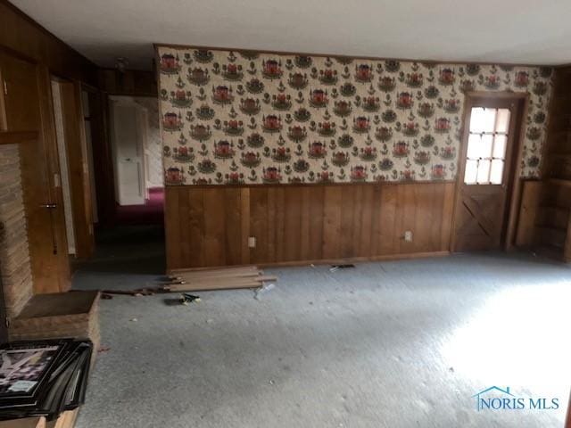 spare room featuring wood walls