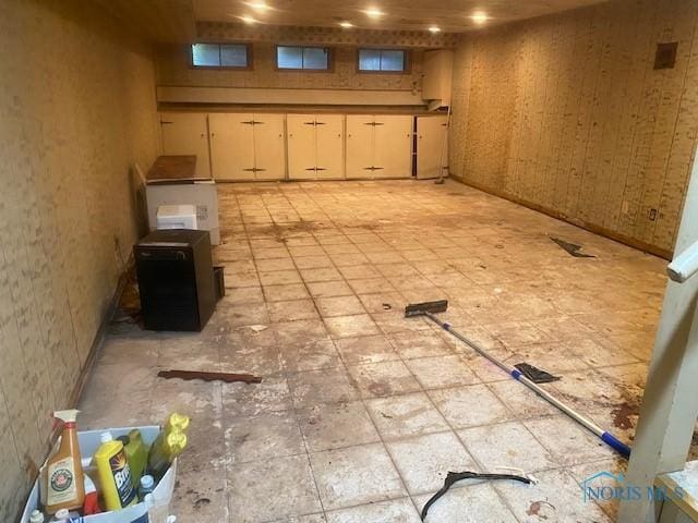 basement featuring wood walls