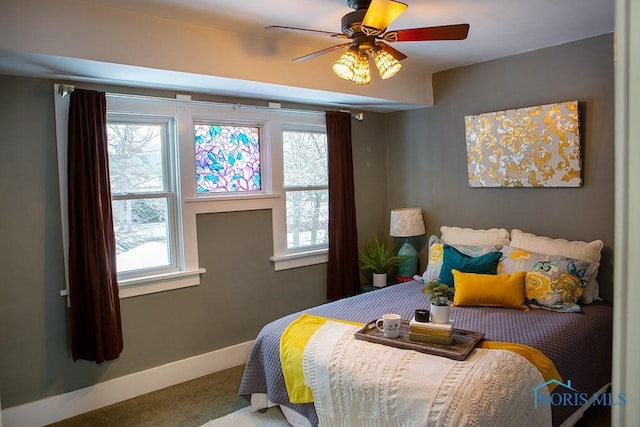 bedroom featuring ceiling fan and carpet