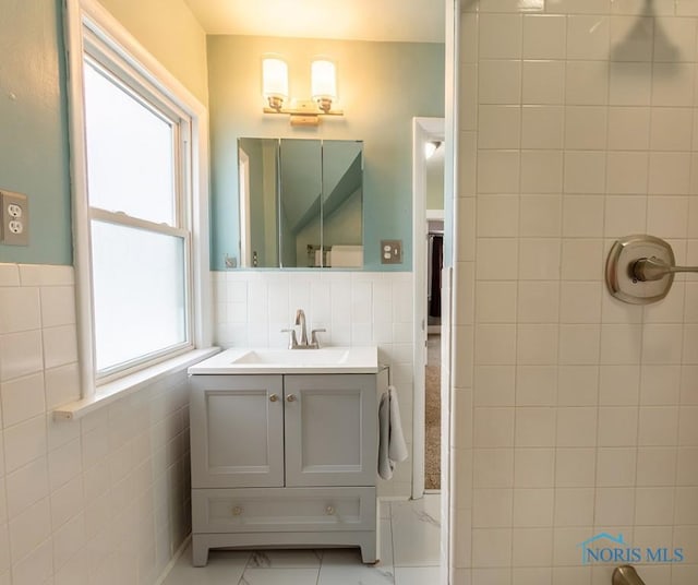 bathroom featuring tile walls and vanity