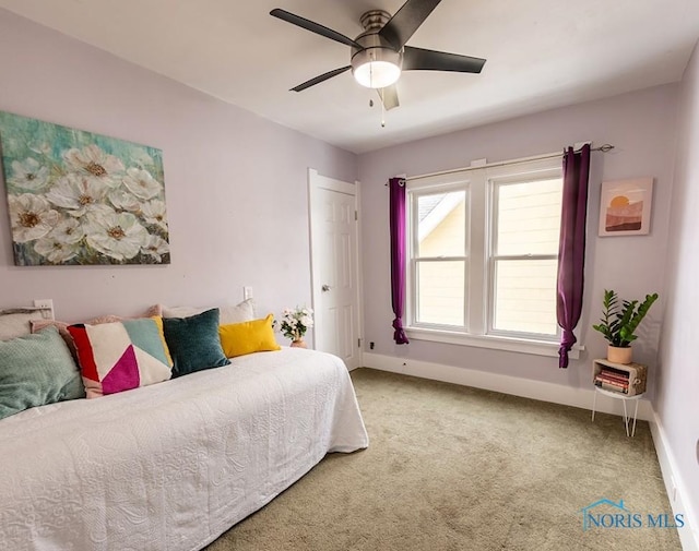 bedroom with ceiling fan and carpet