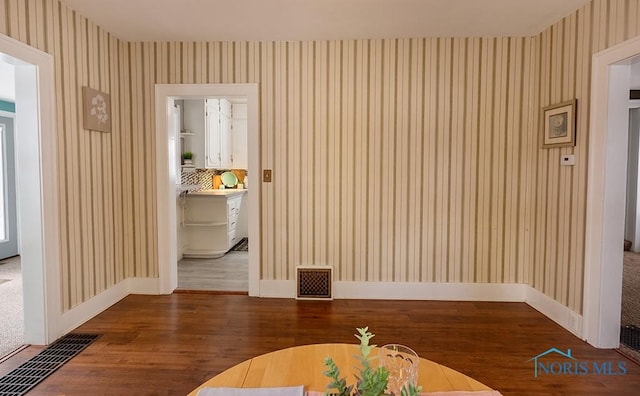 unfurnished dining area featuring wood-type flooring