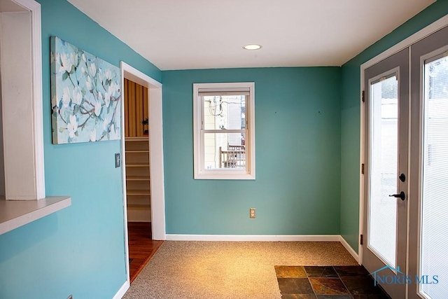 entryway with french doors and dark carpet