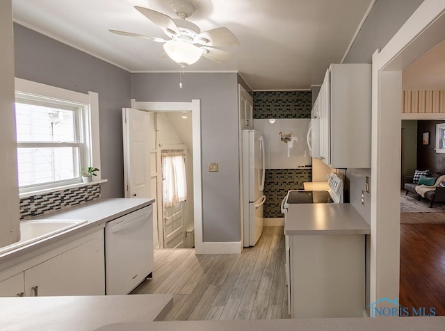 kitchen featuring white appliances, white cabinets, ceiling fan, and light hardwood / wood-style floors