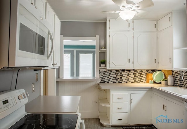 kitchen featuring sink, white cabinetry, white appliances, ceiling fan, and tasteful backsplash