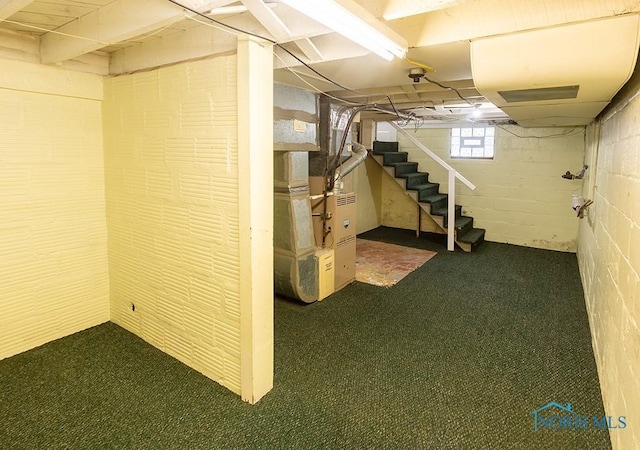 basement featuring heating unit and dark colored carpet