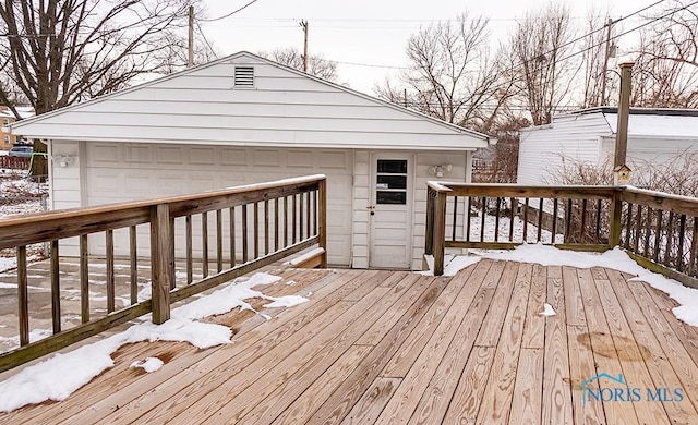 snow covered deck with a garage