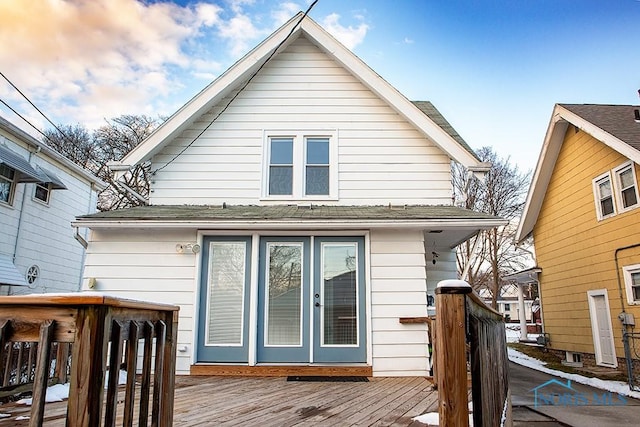 rear view of property featuring a wooden deck