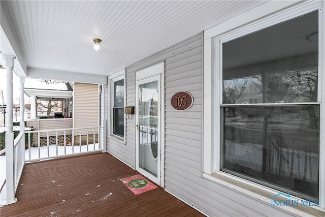 wooden terrace featuring covered porch