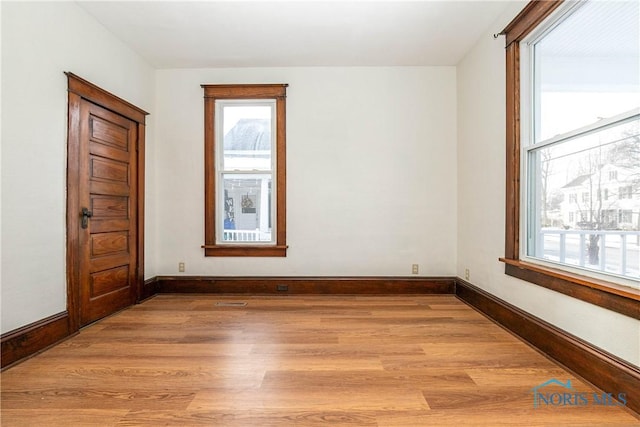 empty room with light hardwood / wood-style floors