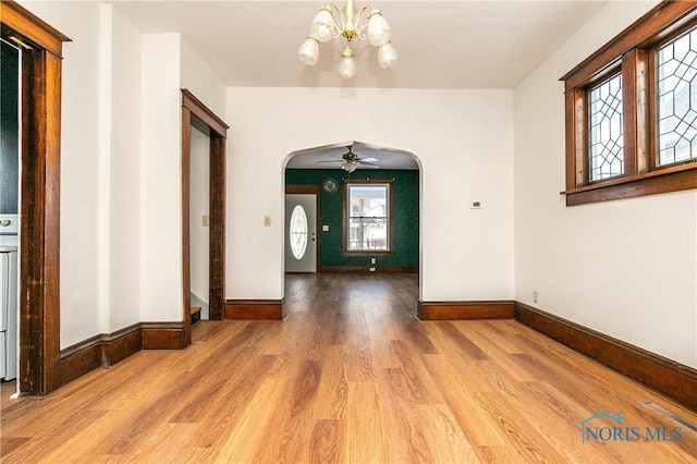 entryway with ceiling fan with notable chandelier and hardwood / wood-style flooring