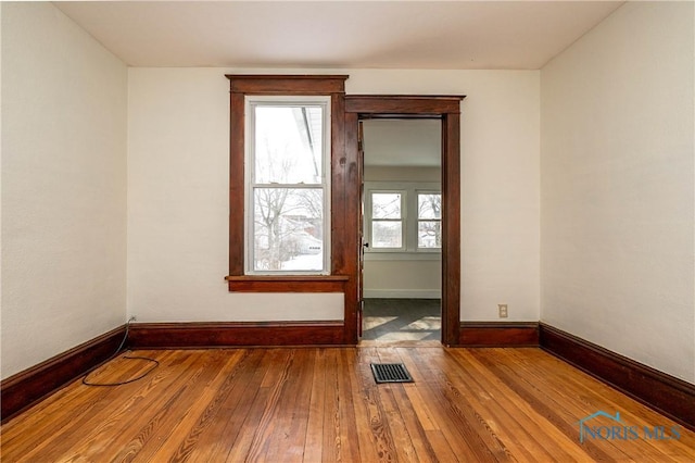 unfurnished room with hardwood / wood-style floors