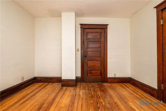 empty room with wood-type flooring