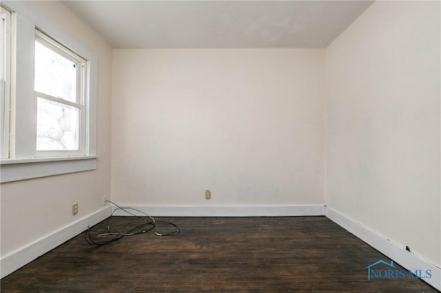 empty room featuring dark hardwood / wood-style flooring