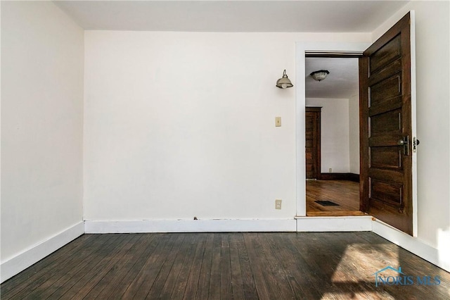 empty room with dark hardwood / wood-style floors